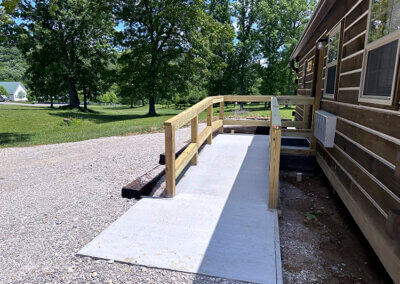 FRONT OF HANDICAP FRIENDLY RAMP LEADING UP TO THE FRONT DOOR ON THE MAPLE CABIN